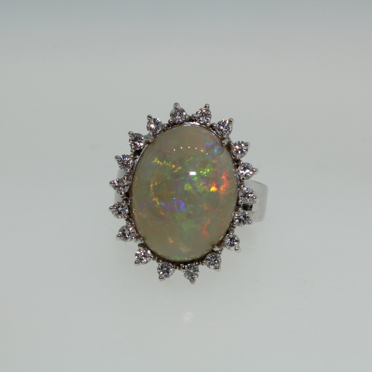 Large Opal ring with diamond surround on a light gray background