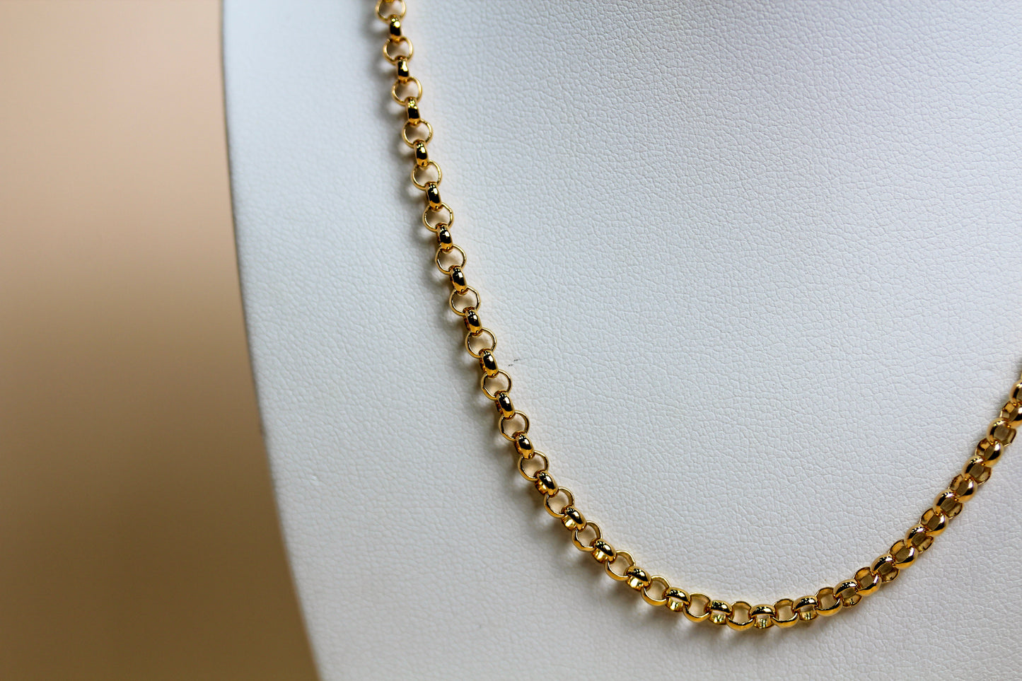 Close-up of solid 9ct yellow gold bold belcher links with polished ball connectors, high-polish finish