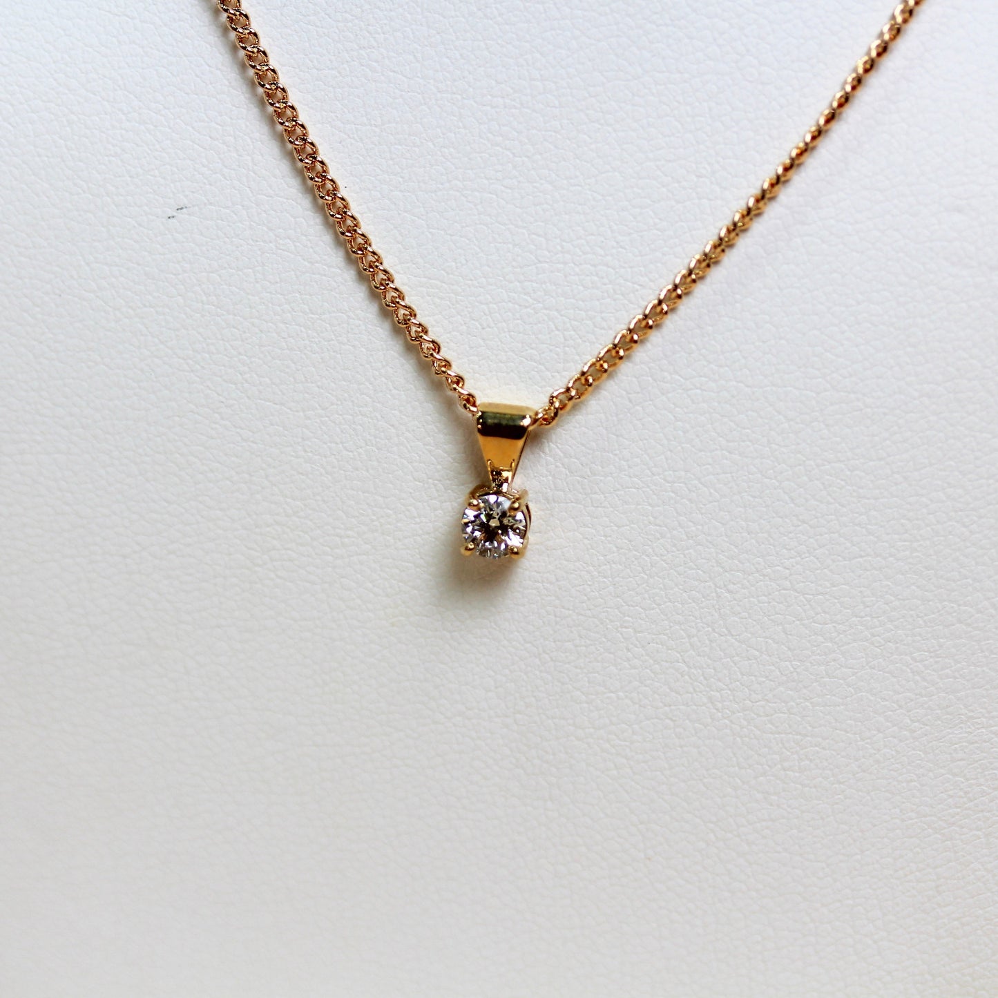 Close-up of 0.26ct lab diamond in four-claw 9ct yellow gold solitaire setting — Jon Crosbie Jeweller