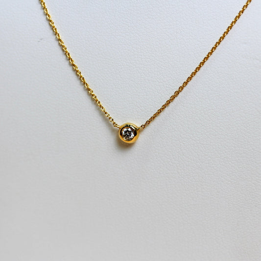 Close-up of natural diamond in smooth 18ct yellow gold full bezel setting — Jon Crosbie Jeweller