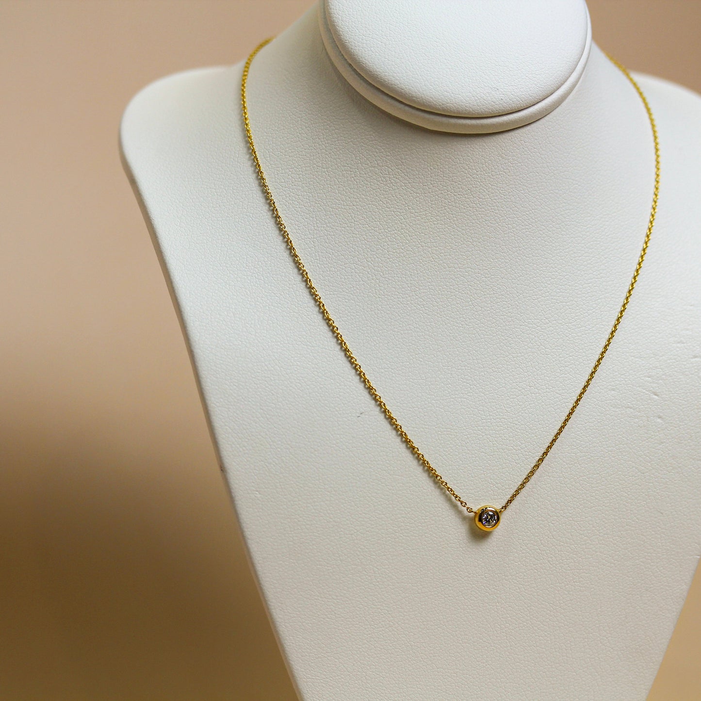 Natural diamond solitaire bezel necklace in 18ct yellow gold, round brilliant diamond in full bezel setting on fine cable chain