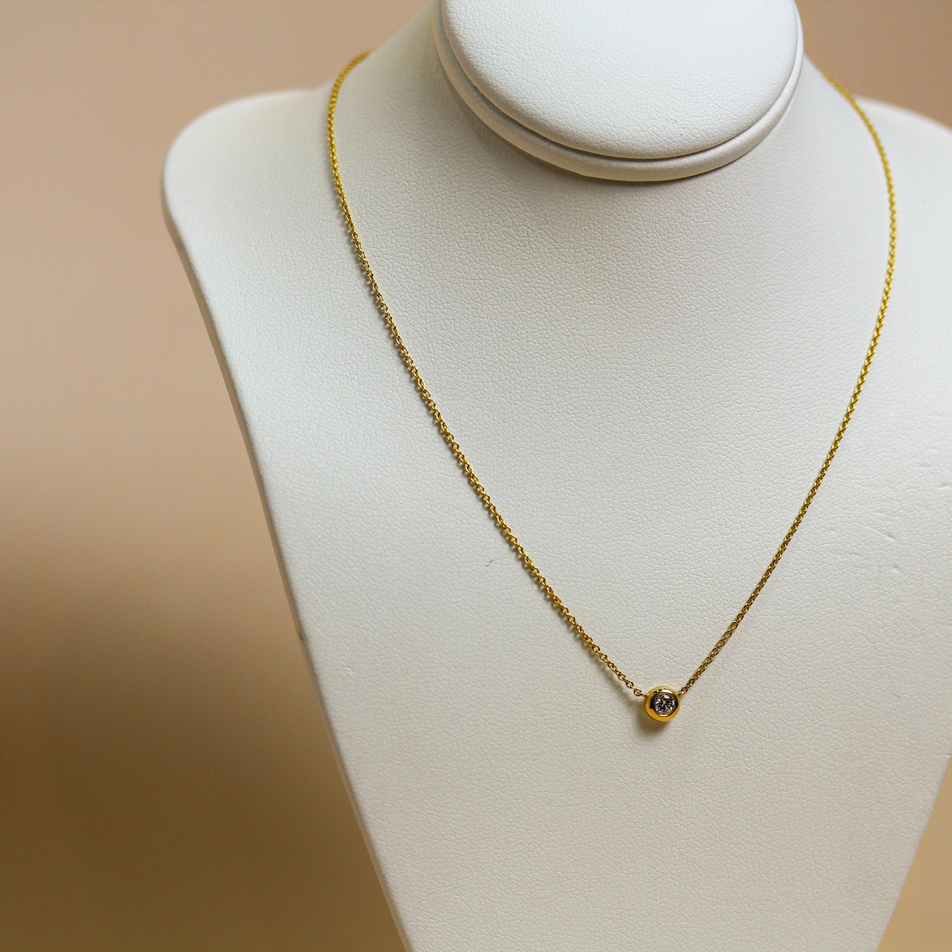 Natural diamond solitaire bezel necklace in 18ct yellow gold, round brilliant diamond in full bezel setting on fine cable chain