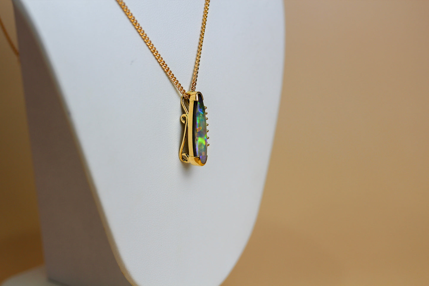 Reverse of handmade 18ct gold boulder opal pendant showing hand-engraved scroll detail — Jon Crosbie Jeweller