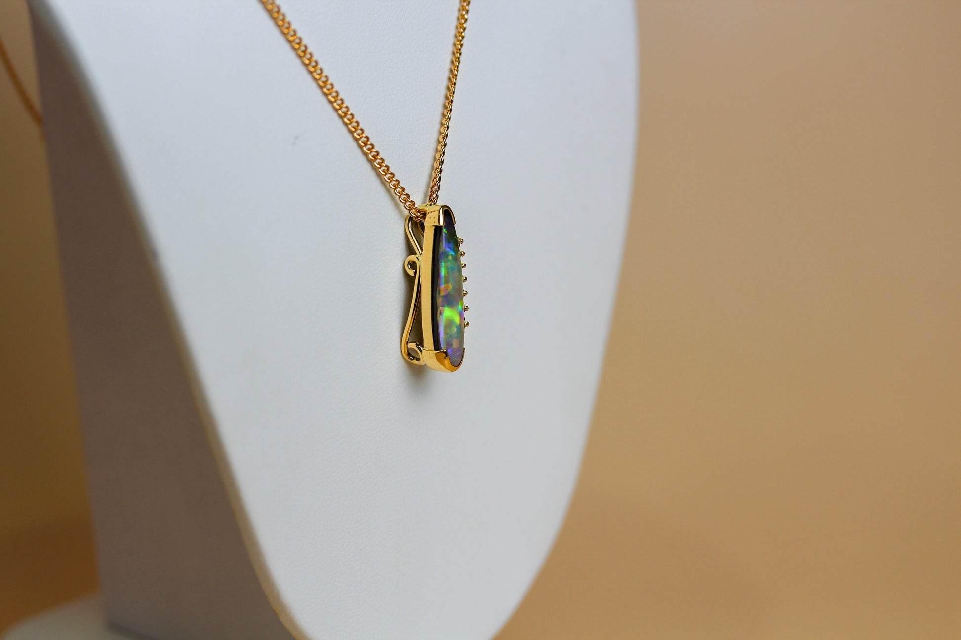 Reverse of handmade 18ct gold boulder opal pendant showing hand-engraved scroll detail — Jon Crosbie Jeweller
