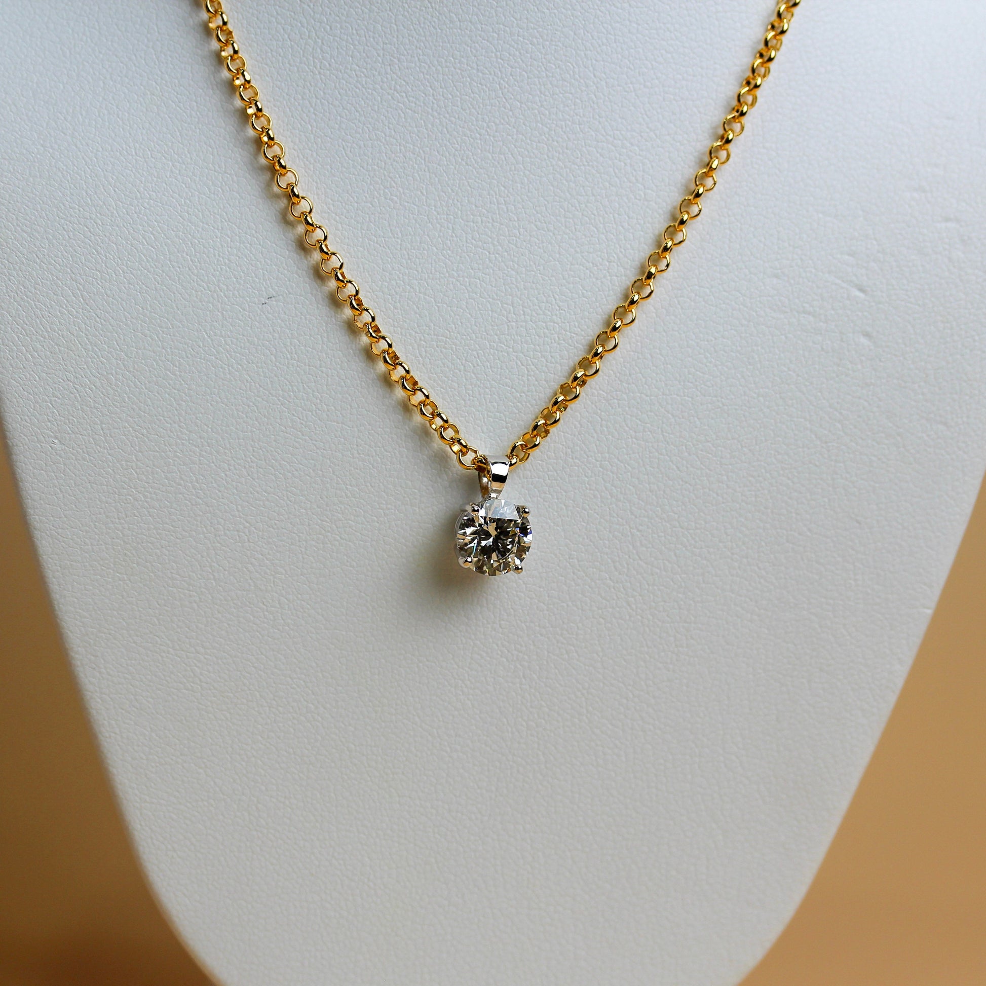 Close-up of 1.54ct lab diamond in white gold four-claw solitaire setting on yellow gold belcher chain — Jon Crosbie Jeweller